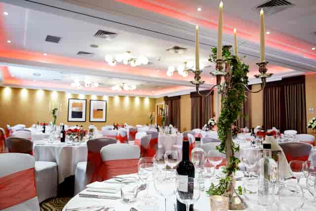 Elegant Kings Suite banquet room with white linens, perfect for weddings and corporate events.