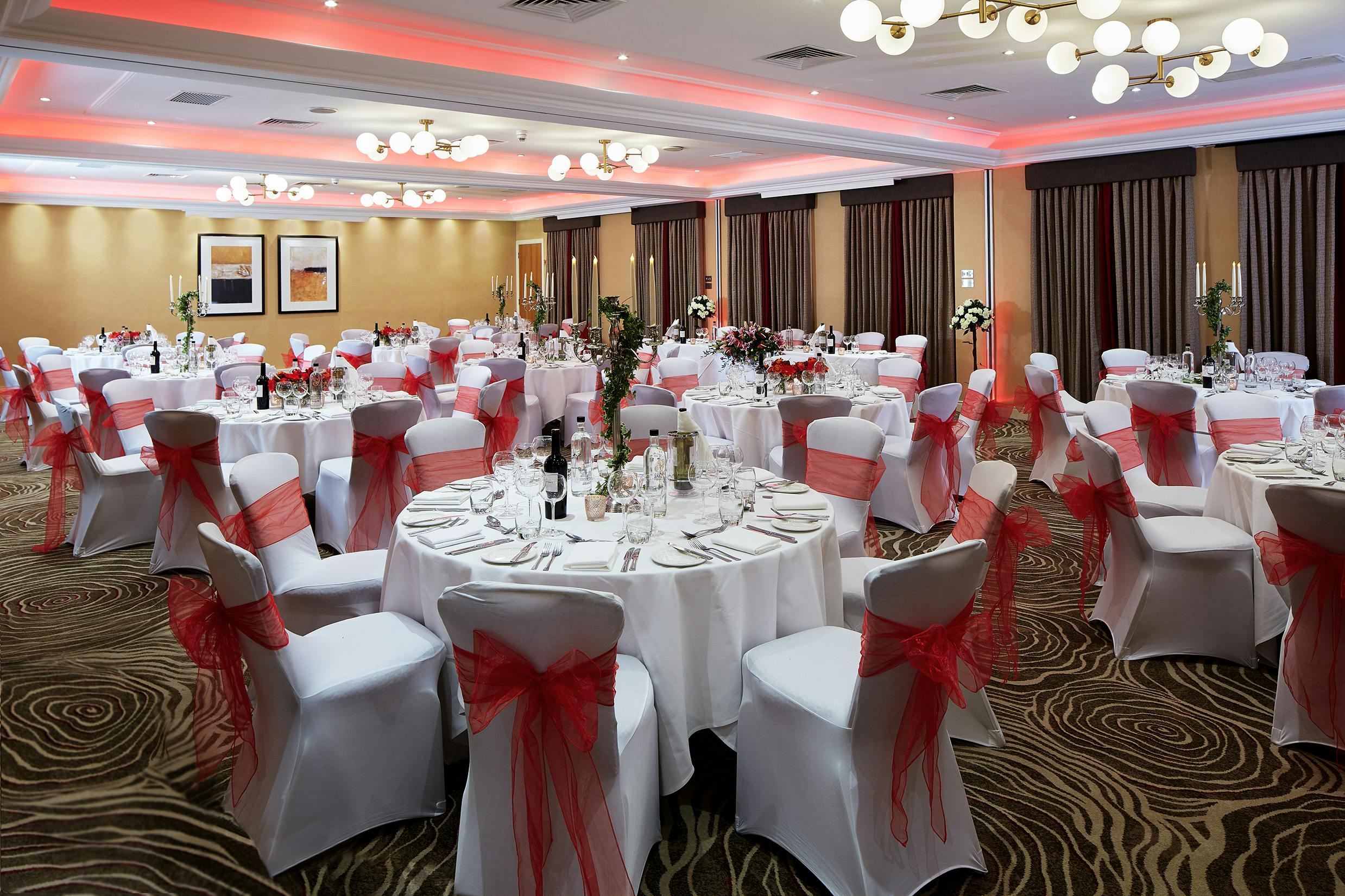 Elegant Kings Suite banquet hall with white linens, perfect for weddings and formal events.