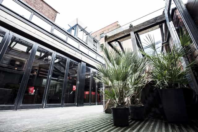 Versatile event space with large windows at Brickhouse Social for corporate and social gatherings.