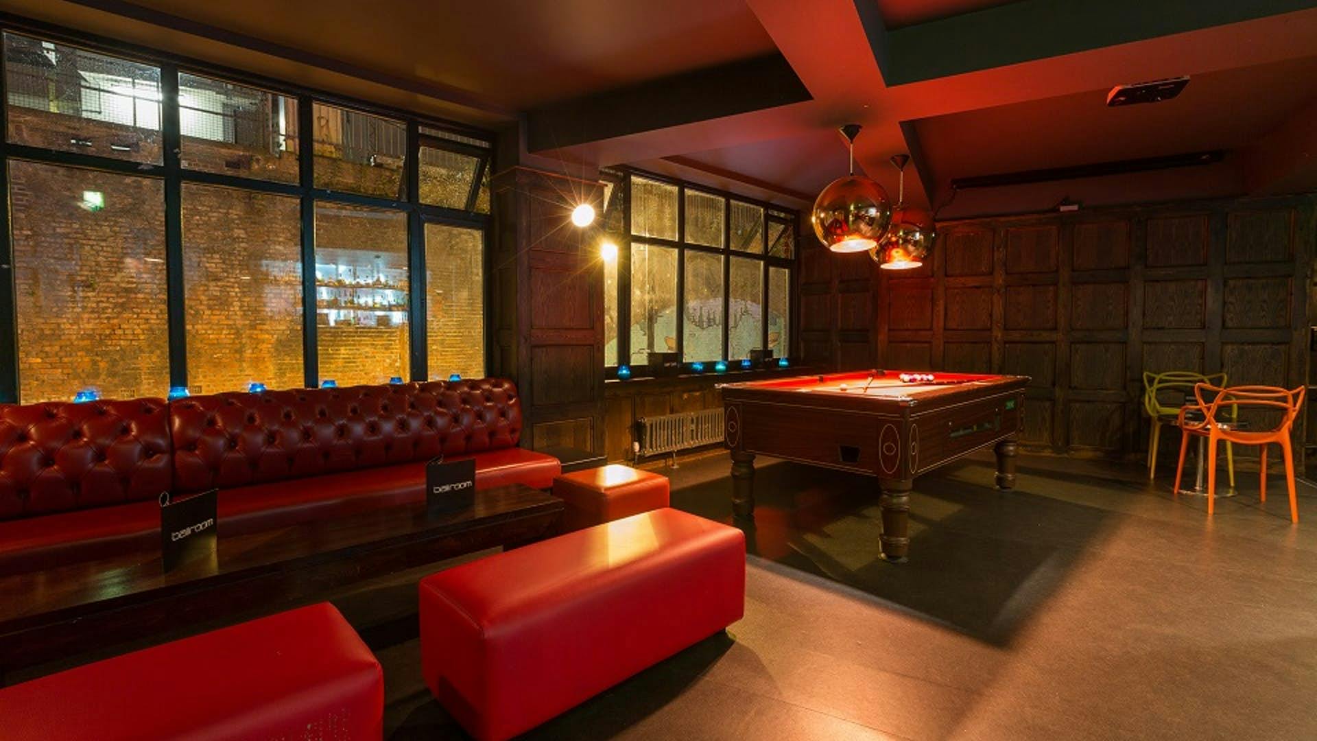 Stylish lounge with plush red seating for networking events at Brickhouse Social.