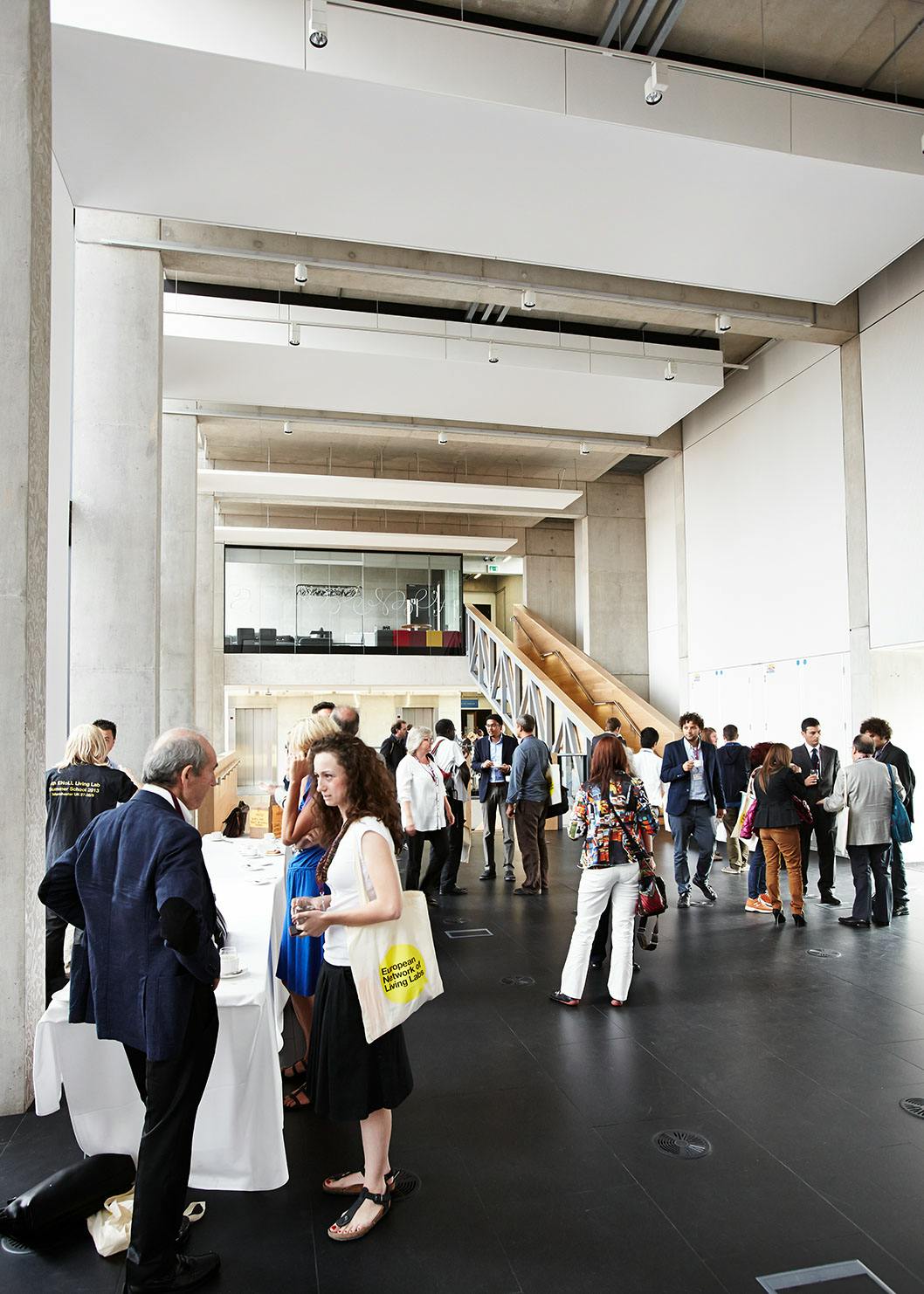 Vibrant networking event in Benzie Building with attendees engaging in conversation.