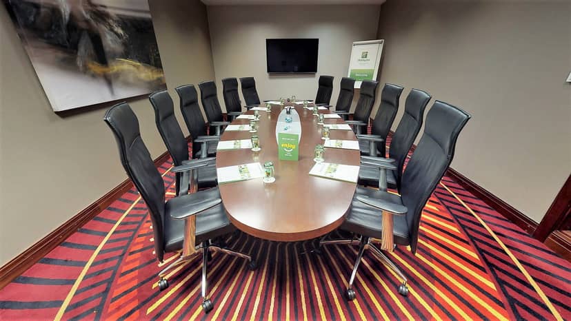 Modern conference room with ergonomic chairs at Holiday Inn Kensington for meetings and events.