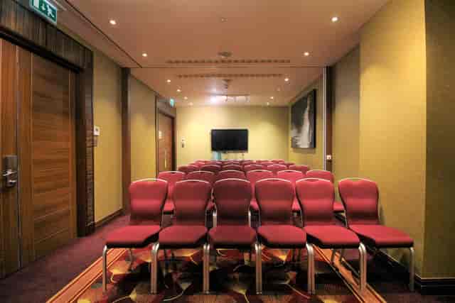 St James Suite at Holiday Inn London: Maroon chairs for corporate meetings and workshops.