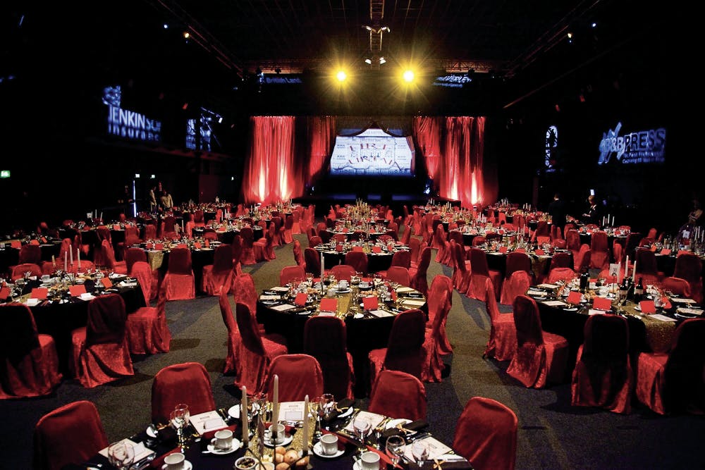 Elegant banquet hall with red tablecloths, ideal for corporate events and galas.