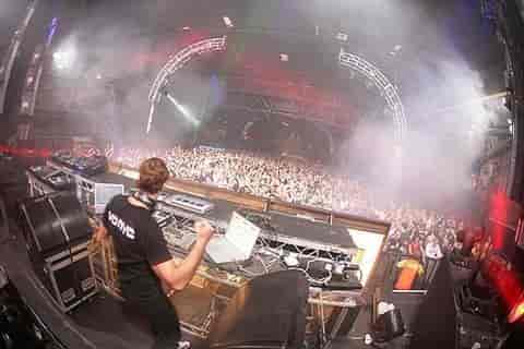 Dynamic crowd at MAGNA's Big Hall with DJ booth, music event atmosphere.