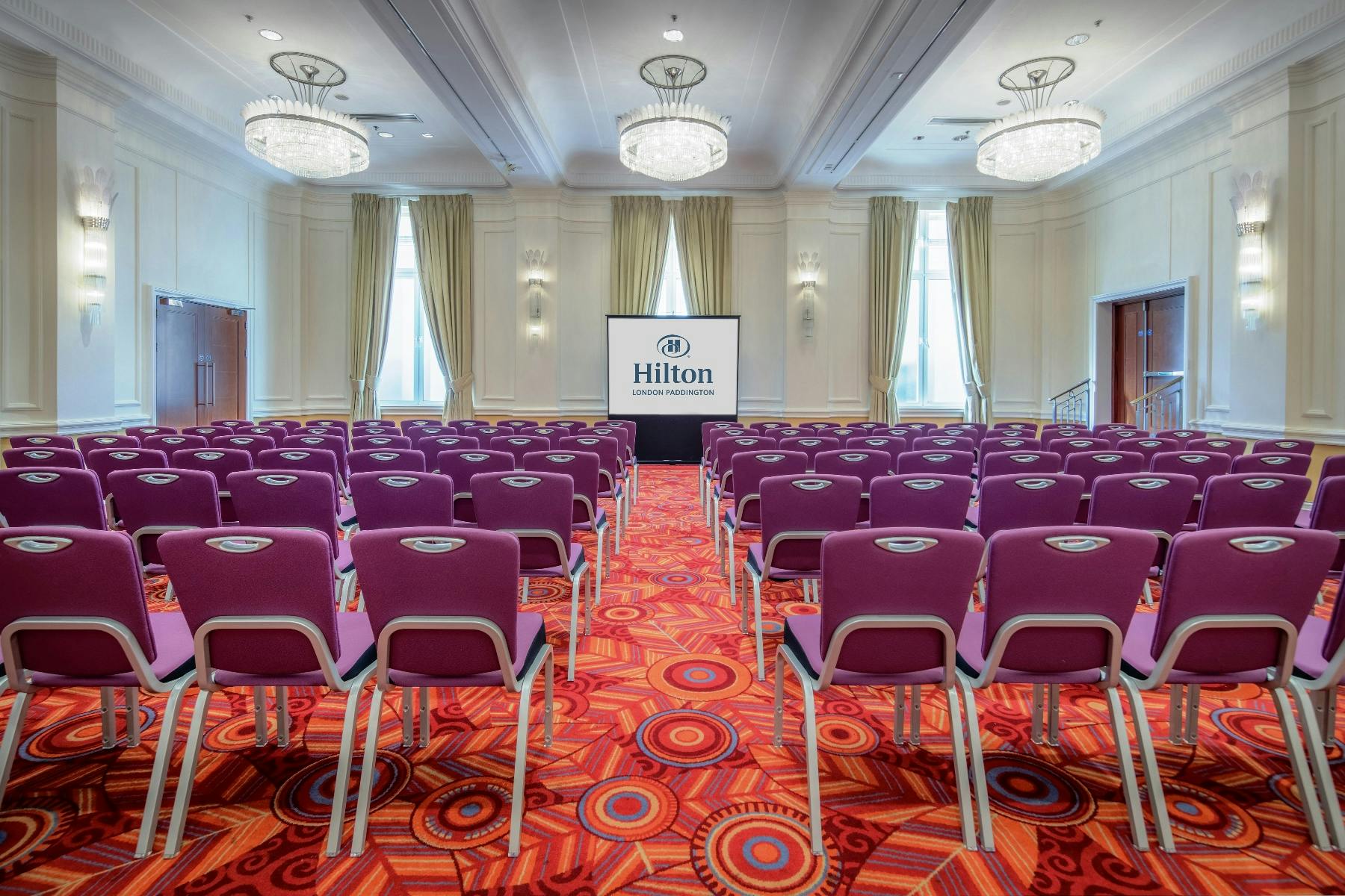 Great Western 2 meeting space at Hilton London Paddington with purple chairs for conferences.