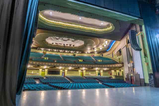 Spacious auditorium with grand stage at Eventim Apollo, ideal for conferences and performances.