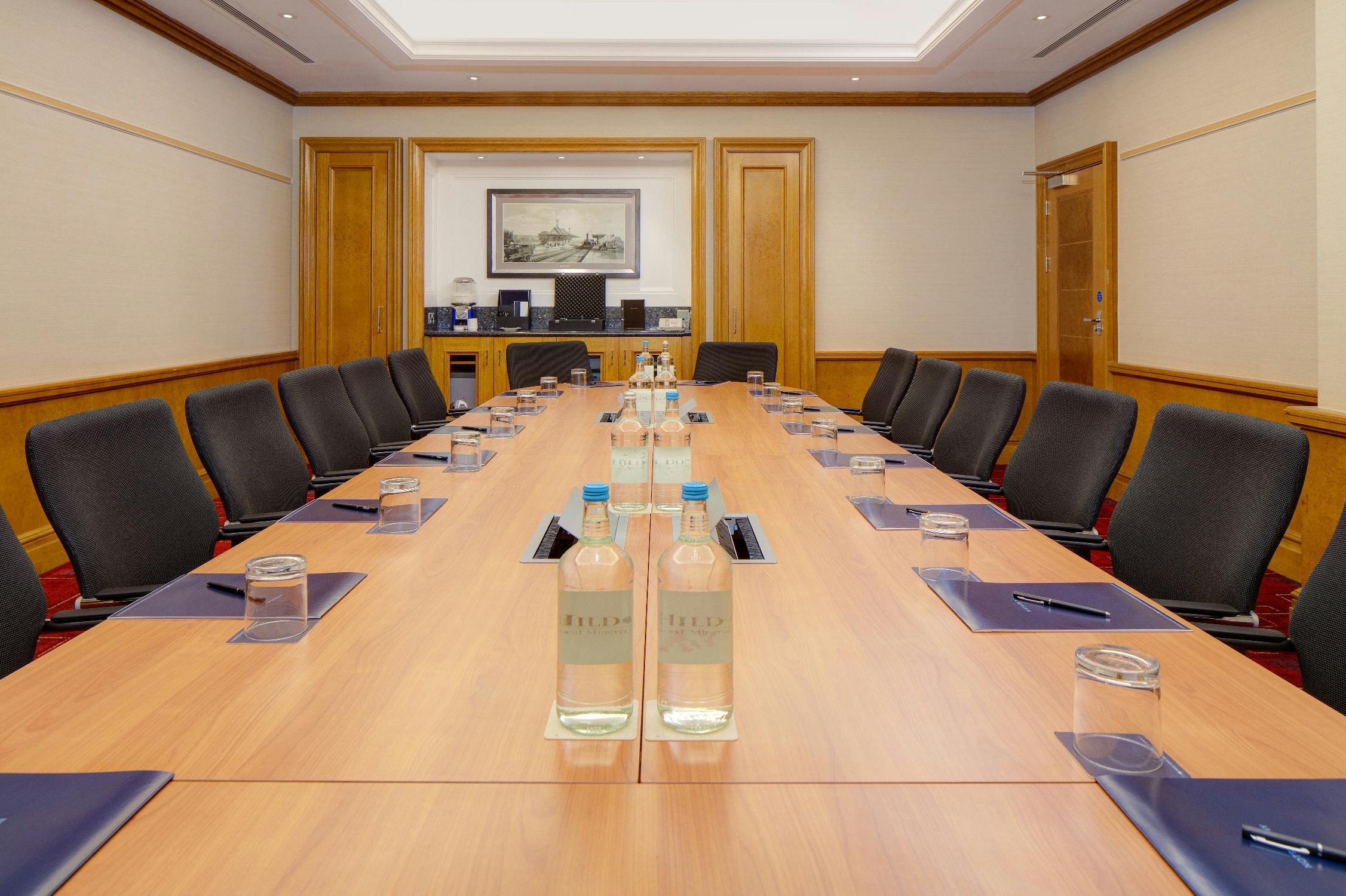 Conference room at Hilton London Paddington, featuring a long wooden table for meetings.