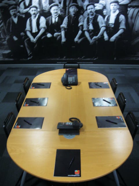Conference room with black-and-white mural, ideal for collaborative meetings and events.