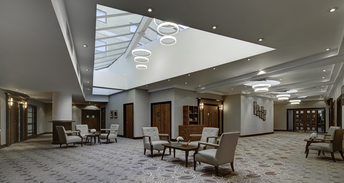 Isaac Newton suite at Hilton Cambridge, modern meeting space with skylight for events. - Banner