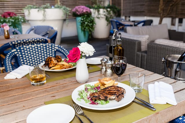 Outdoor dining table with steak, perfect for networking dinners and celebrations.