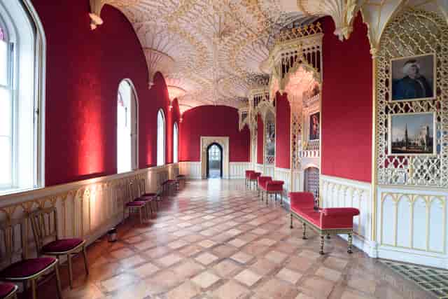 Ornate wedding venue with red walls, ideal for upscale receptions and events.