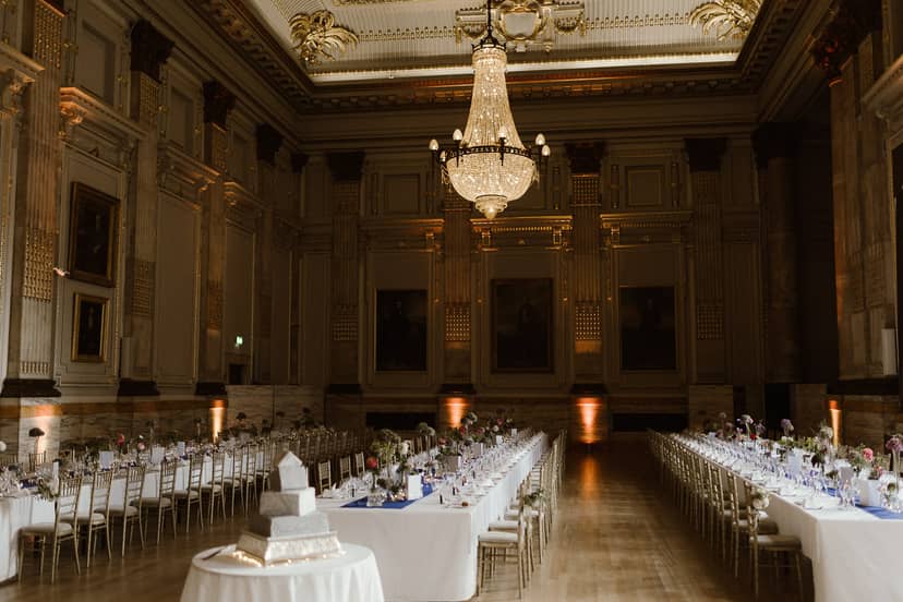 Elegant banquet hall with chandelier, ideal for weddings and corporate events.