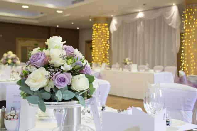 Elegant Wimbledon Room at The Lensbury with floral centerpieces for weddings and events.
