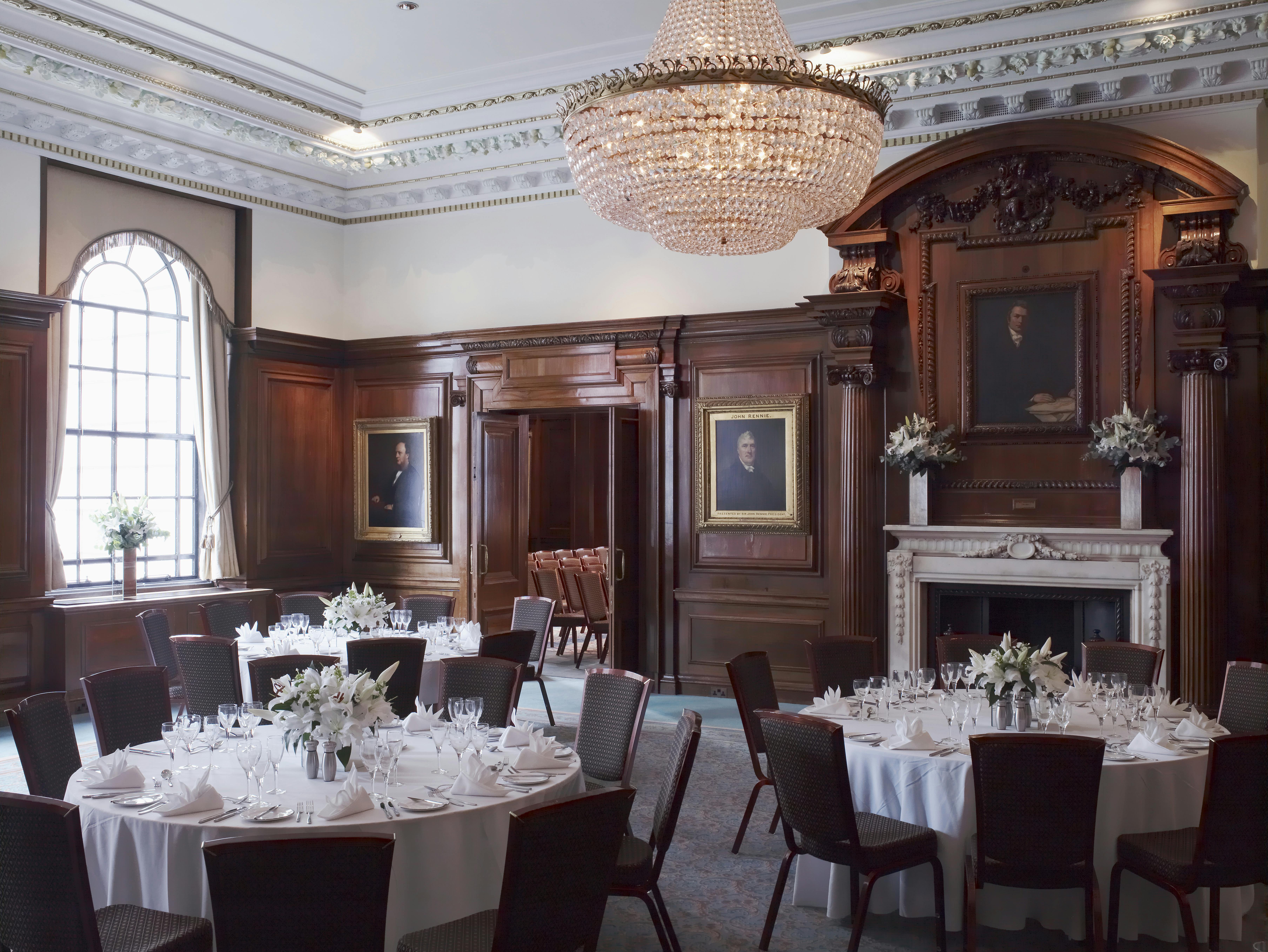 Elegant Brunel Room with round tables, ideal for upscale meetings and banquets.