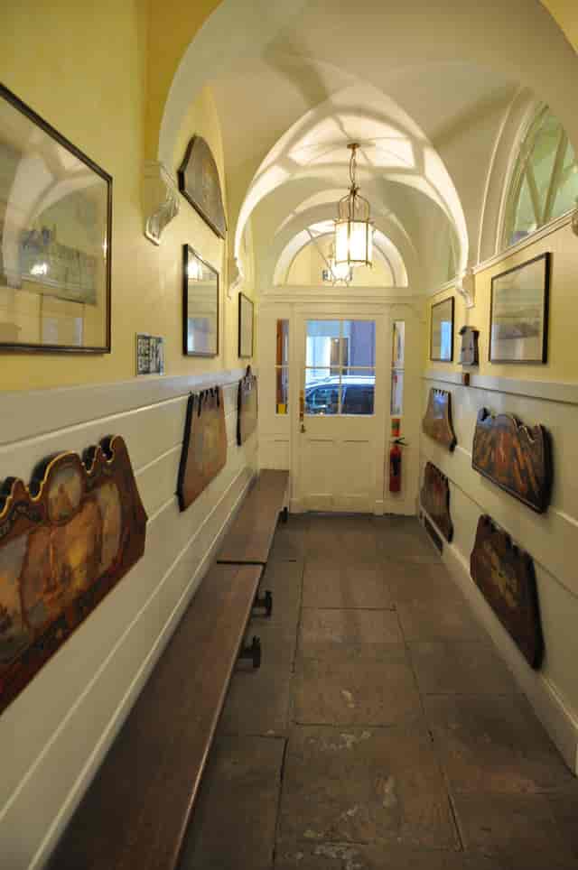 Silver Room hallway with artwork and benches, ideal for events and mingling.