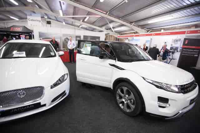 John Hendry Pavilion with luxury cars at an automotive trade show event.