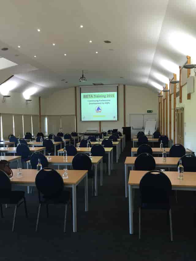 Astor Pavilion training room setup for professional development event with projector screen.