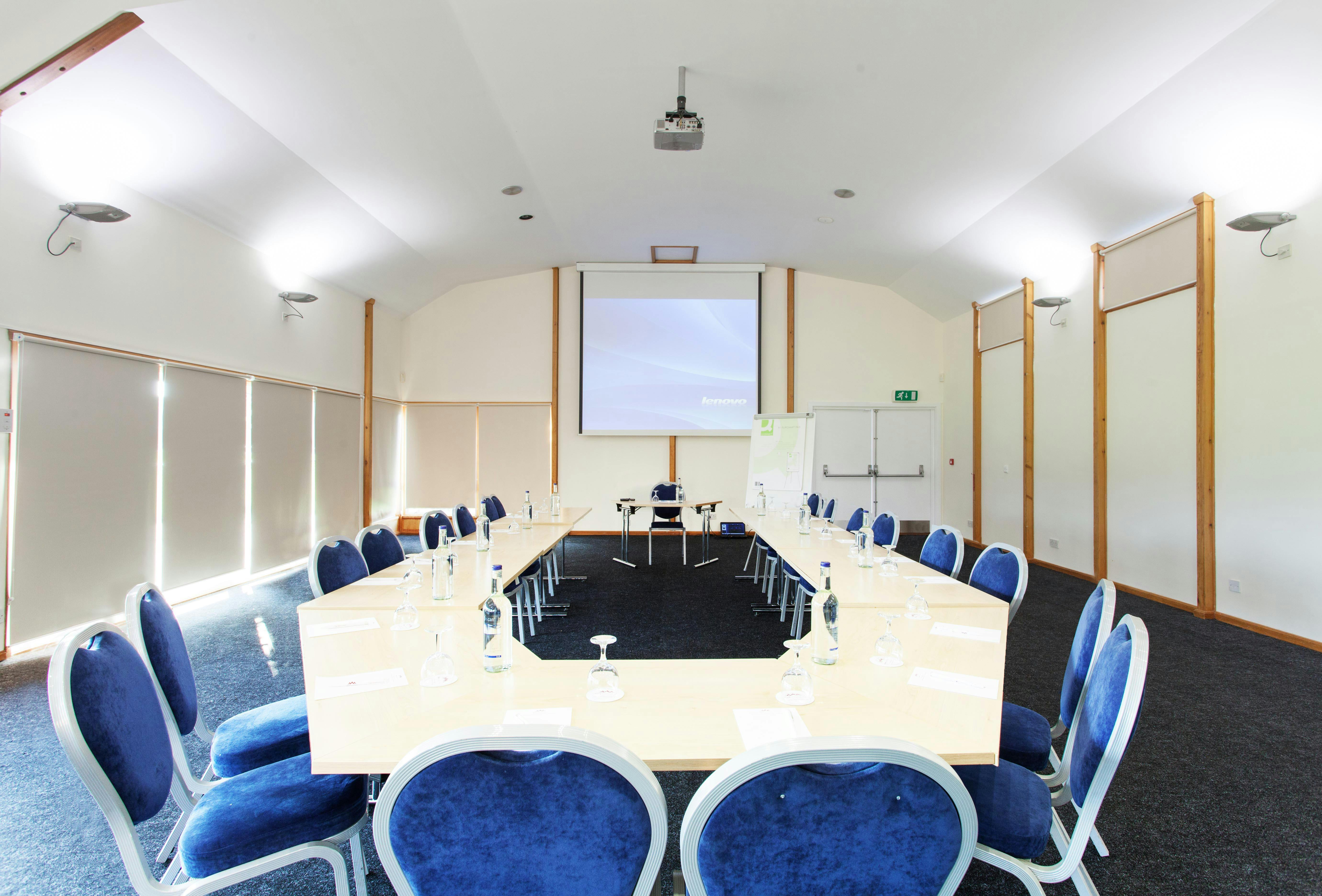 Astor Pavilion meeting room with large table, ideal for professional events and presentations.