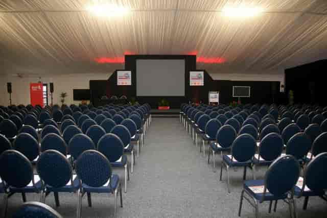Clive Emson Conference Hall setup for a professional conference with blue chairs and large screen.