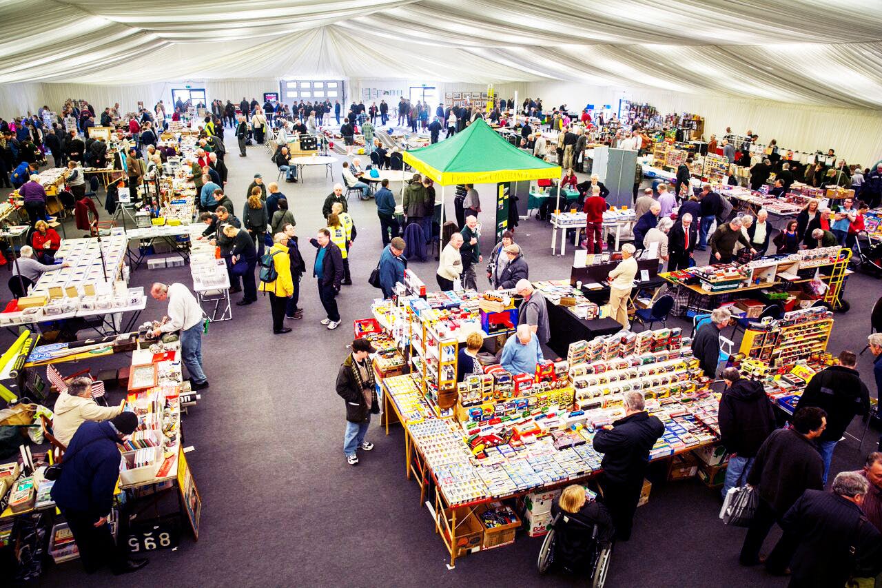 Clive Emson Conference Hall bustling indoor market event with vibrant vendor displays.