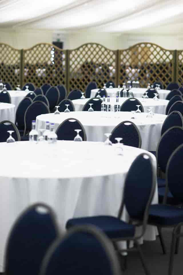 Stockbury Room at Kent Event Centre, elegant round tables set for networking event.