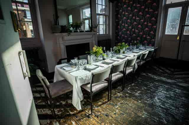 Elegant long dining table in The Sanctuary, ideal for private dinners and gatherings.