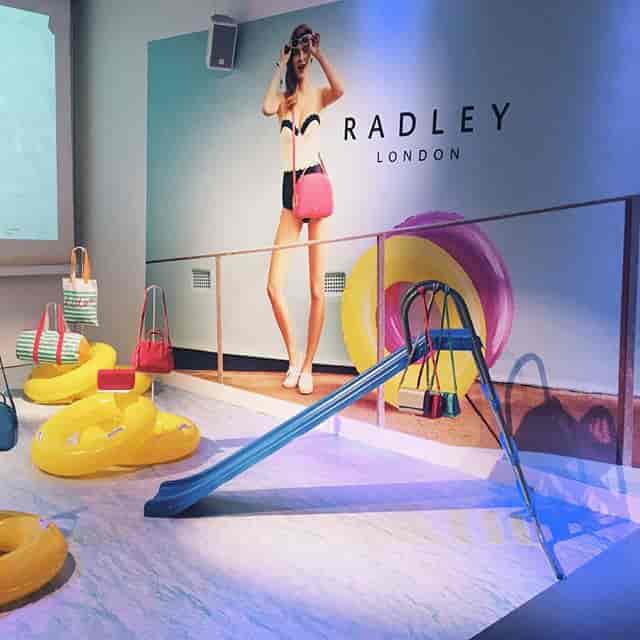 Vibrant event space for Radley London showcasing summer-themed fashion products.