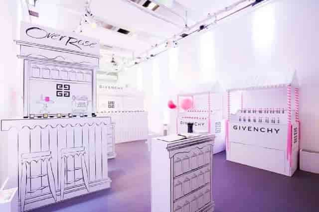 Whimsical event space with illustrated booths for luxury brands, ideal for product launches.