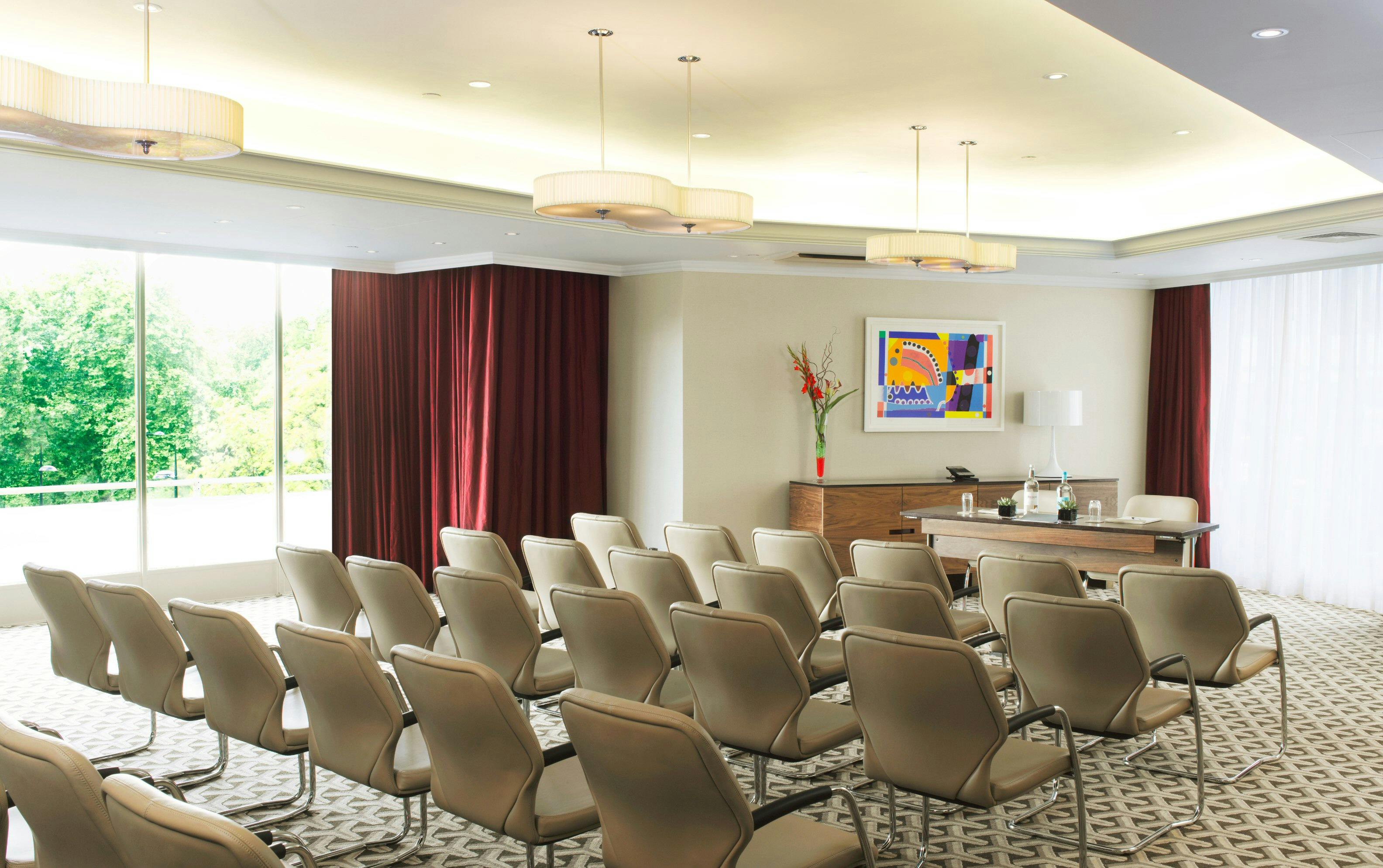 Serpentine Suite at London Hilton: modern meeting room with natural light for events.