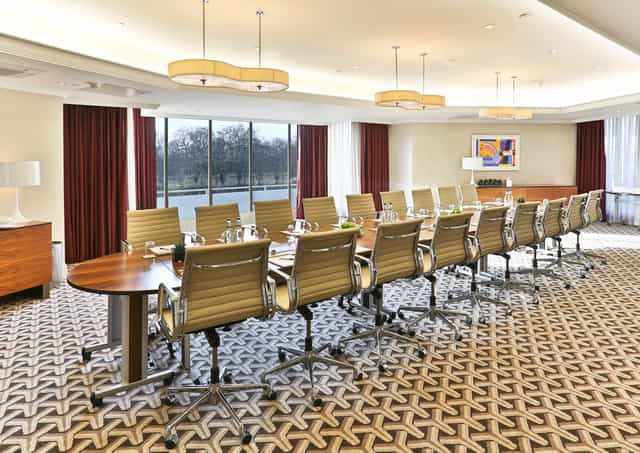 Serpentine Suite conference room with polished table, ideal for corporate events in London.
