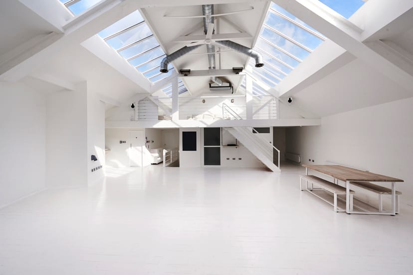 Bright, spacious event venue with high ceilings for corporate meetings and workshops.