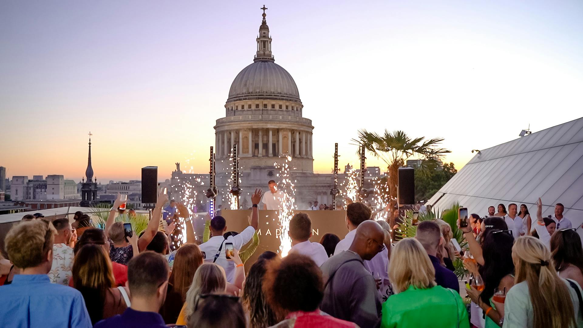 Vibrant rooftop event at Whole Venue, Madison with St. Paul's Cathedral backdrop and sparklers.