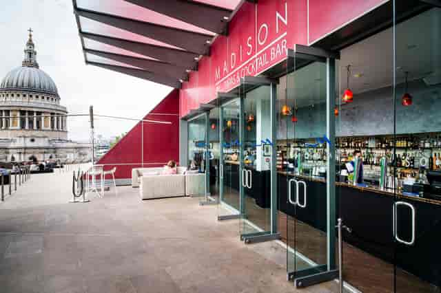 Stylish rooftop venue in Madison with bar, outdoor seating, and views of St. Paul's Cathedral.