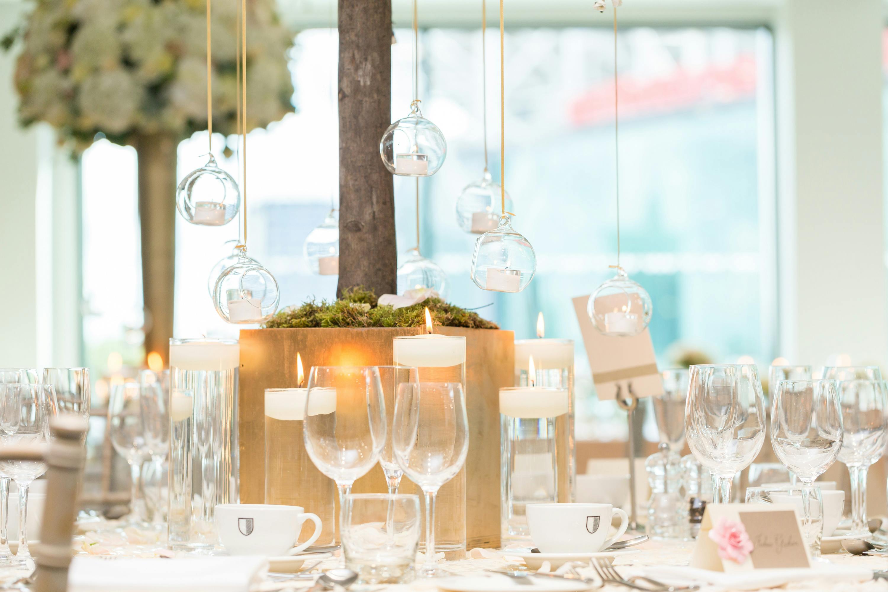 Elegant table setting with tall centerpiece for weddings and corporate events at Hotel Football.