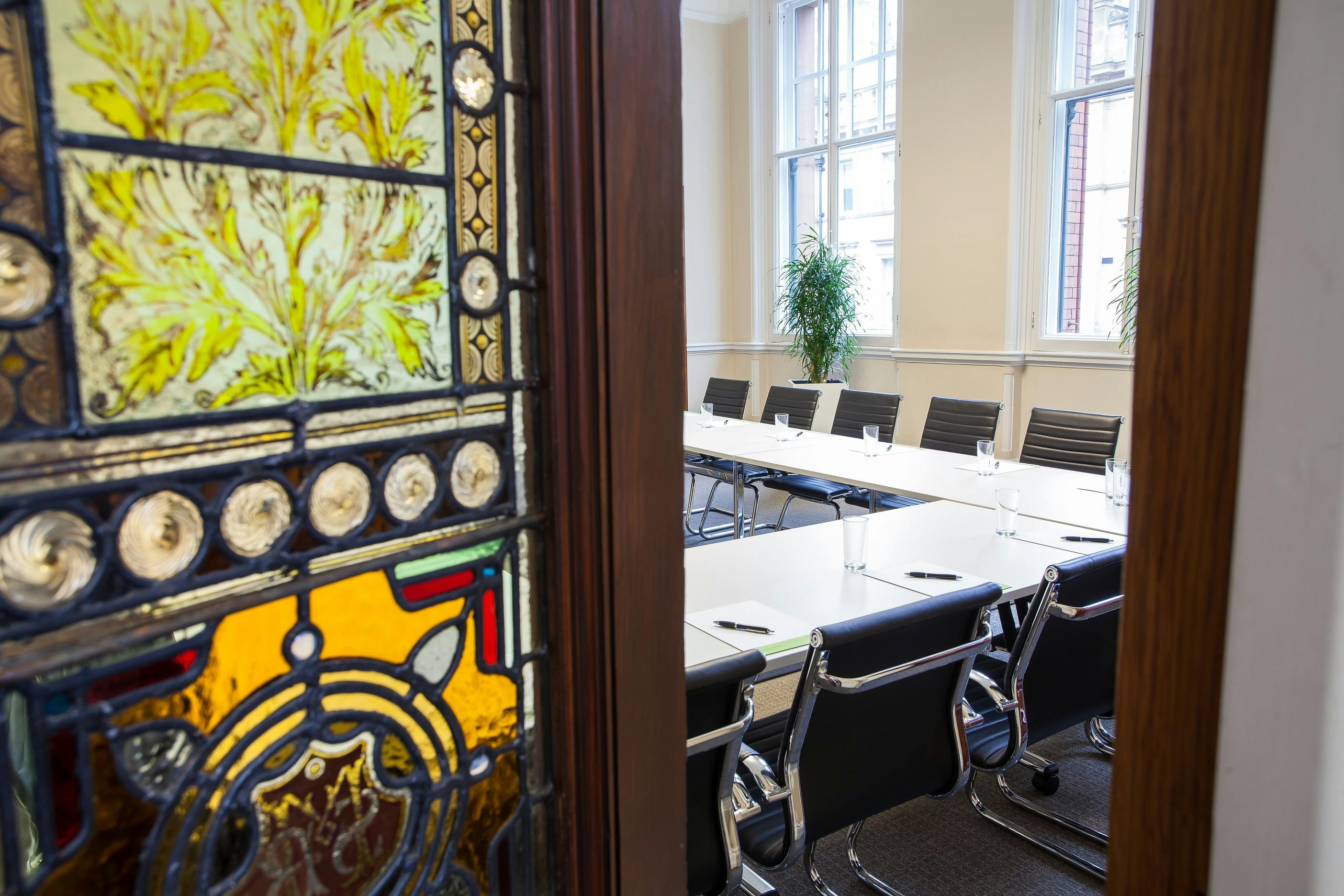Connect Room in Chamber Space: modern meeting room with stained glass door, perfect for events.
