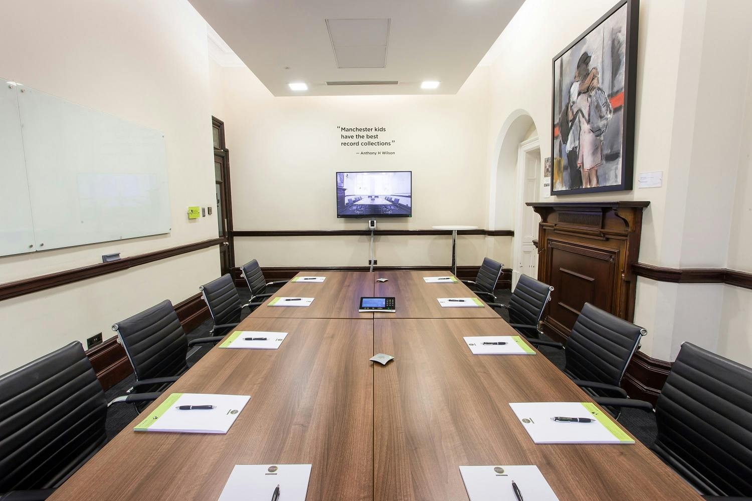 Tony Wilson Room: modern meeting space with sleek table, ideal for professional gatherings.