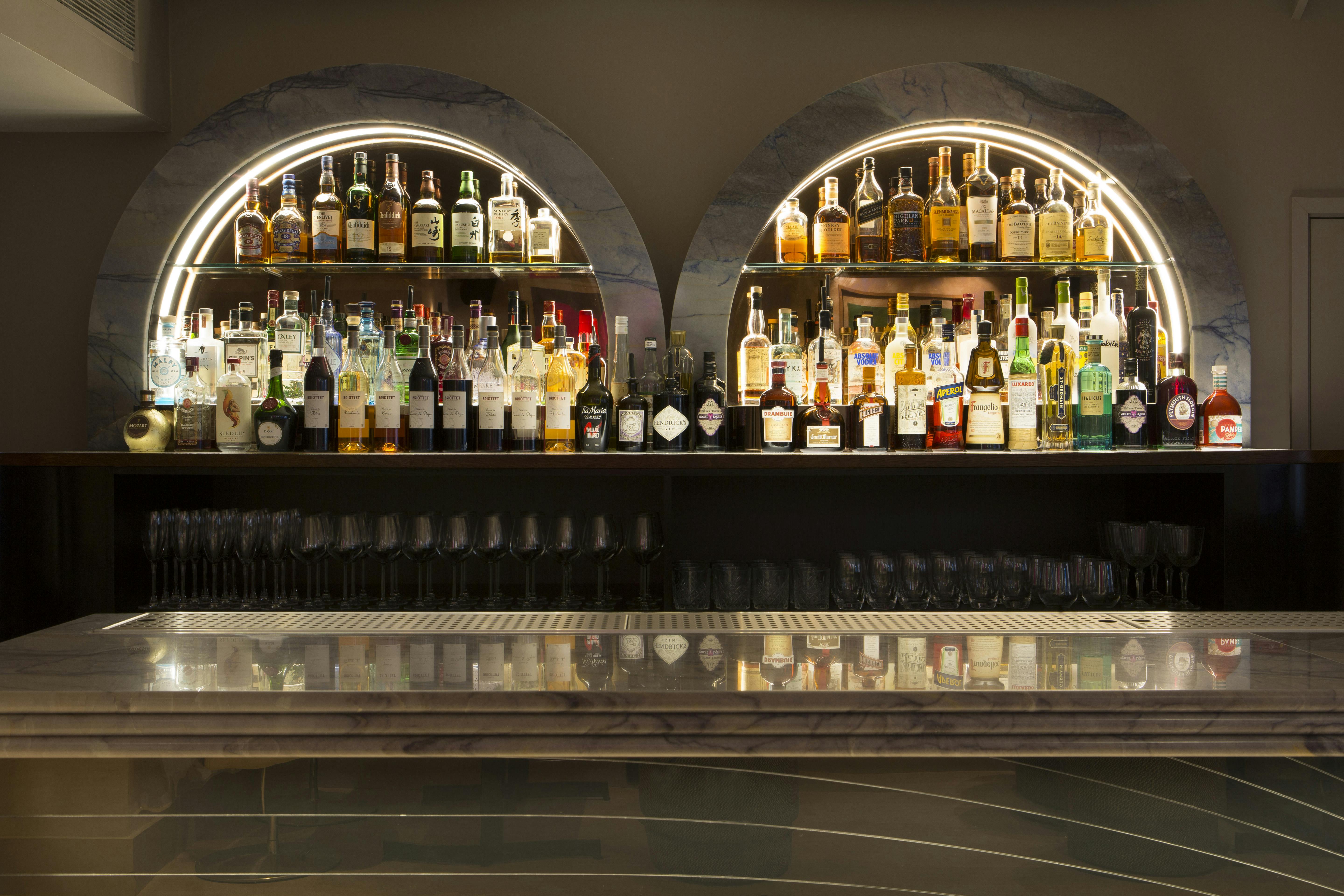 Gennaro Room bar at The Groucho Club with illuminated spirits for upscale events.