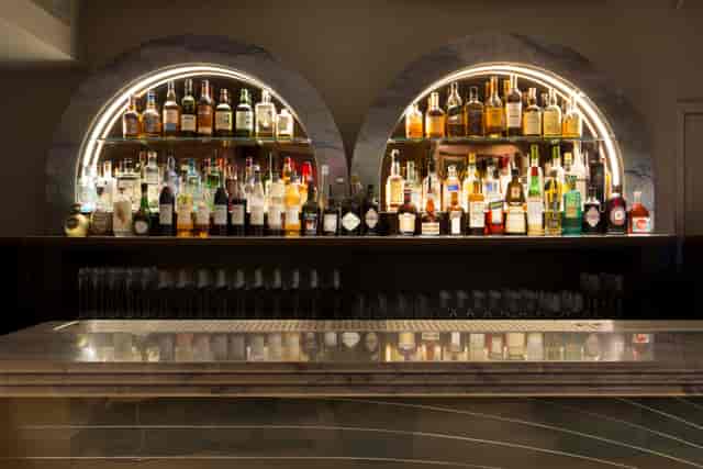 Gennaro Room bar at The Groucho Club with illuminated spirits for upscale events.
