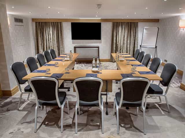 Holland Suite meeting room at Hilton London Kensington, U-shape setup for corporate events.