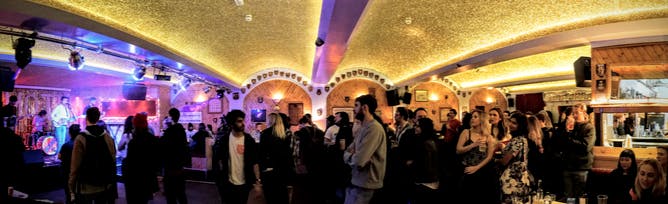 Vibrant Moth Club Main Hall with warm lighting, perfect for networking events.