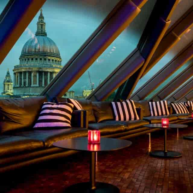Stylish Bar Lounge in Madison with striped cushions and St. Paul's Cathedral view.