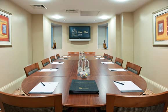 Met 12 meeting room at The Met Hotel, featuring an oval table for professional gatherings.