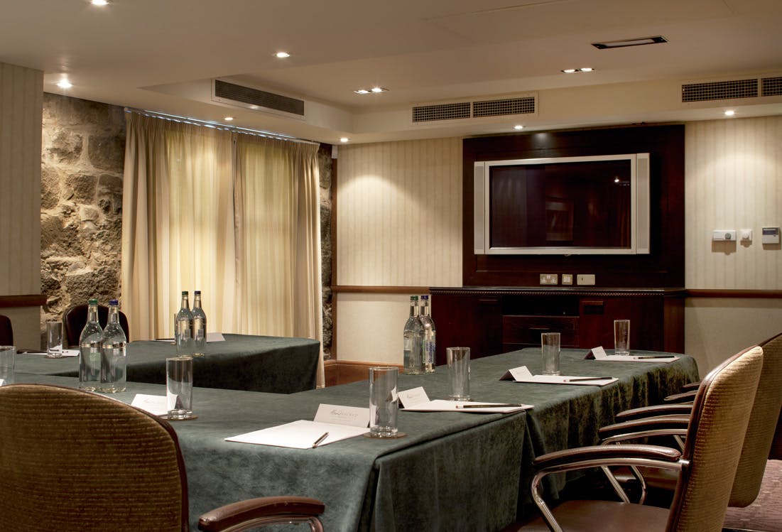 Meeting room at Norton House Hotel with green tablecloths for professional gatherings.