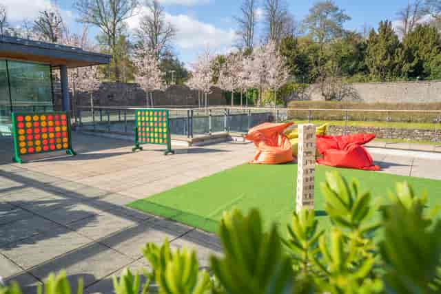 Outdoor breakout space at Norton House Hotel with lawn games for corporate event networking.