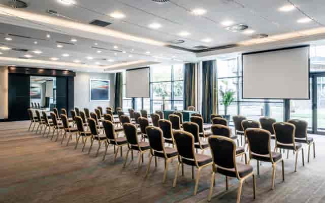 Theater-style conference room with natural light for corporate events and business meetings.