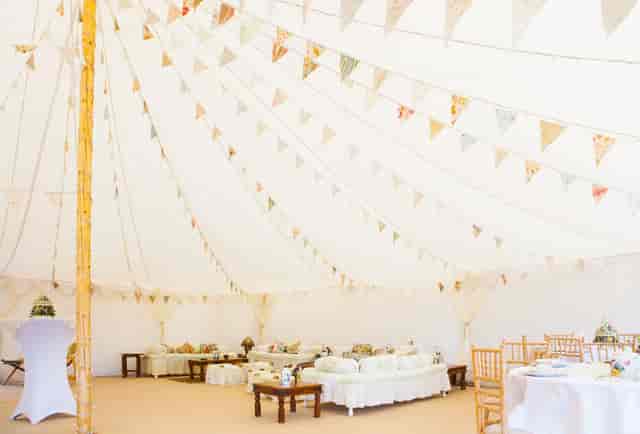 Elegant event tent with draping for weddings and receptions in Plush Tents Glamping.
