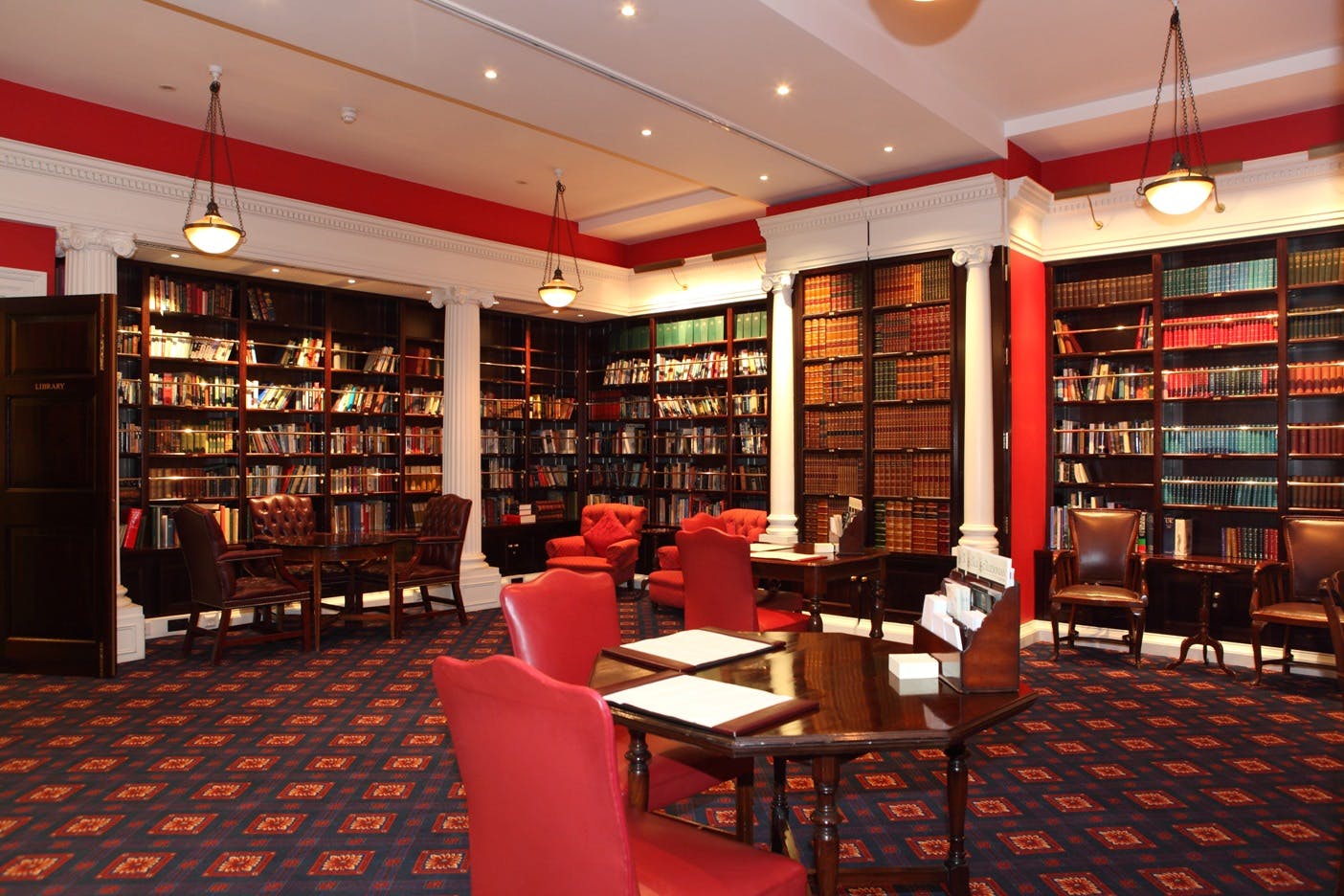 Sophisticated library with rich wood tones, ideal for networking events and private gatherings.