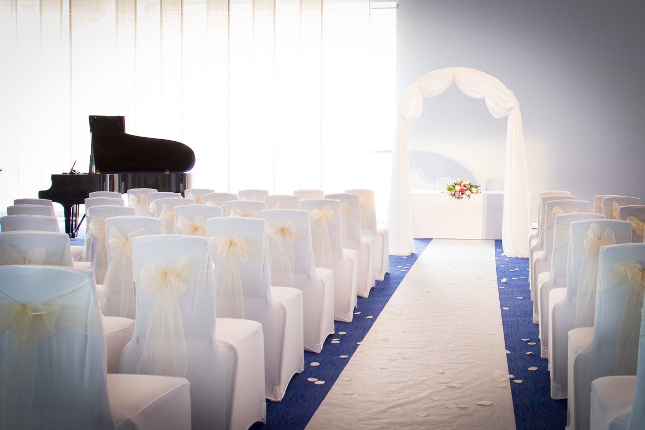 Barbirolli Room wedding setup with elegant chairs and romantic archway.