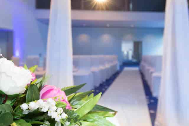 Barbirolli Room wedding venue with elegant floral arrangements and white chairs.